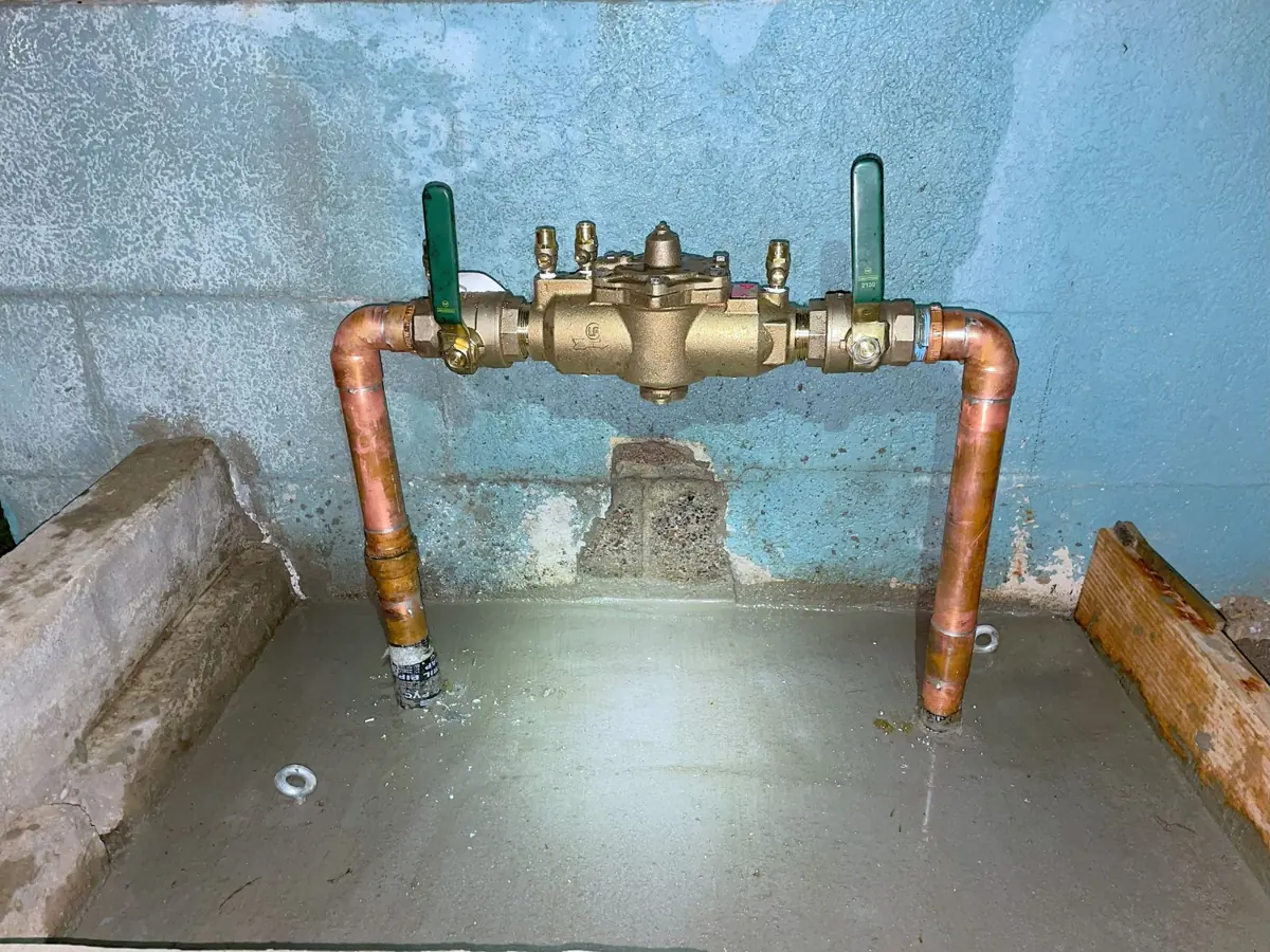 Copper backflow assembly with green valve handles